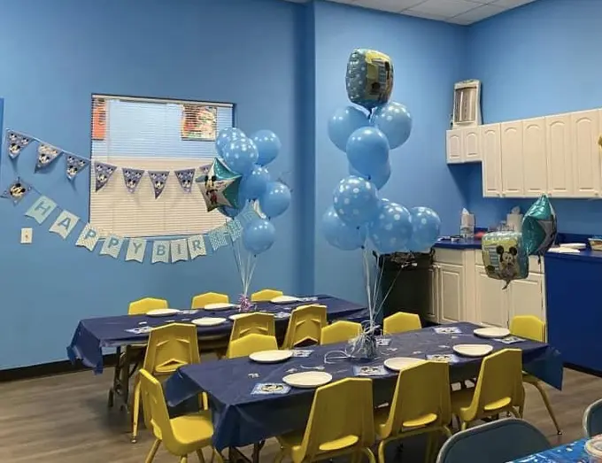 A kids dining room decorated with balloons for birthday