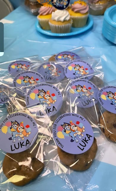 A bunch of cookies with Luka card on top of them
