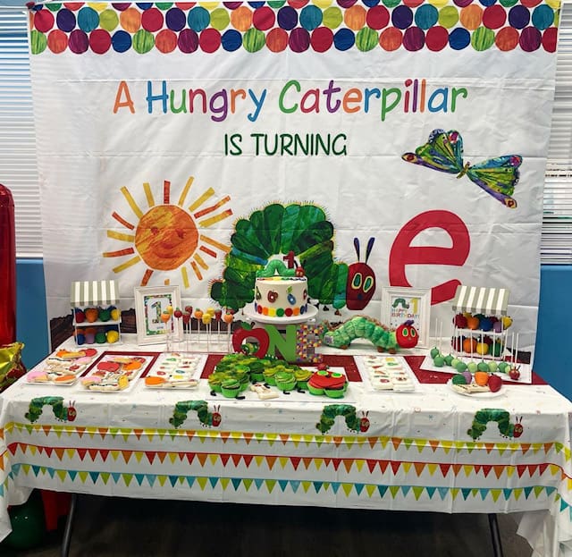 A stand with hungry caterpillar is turning written